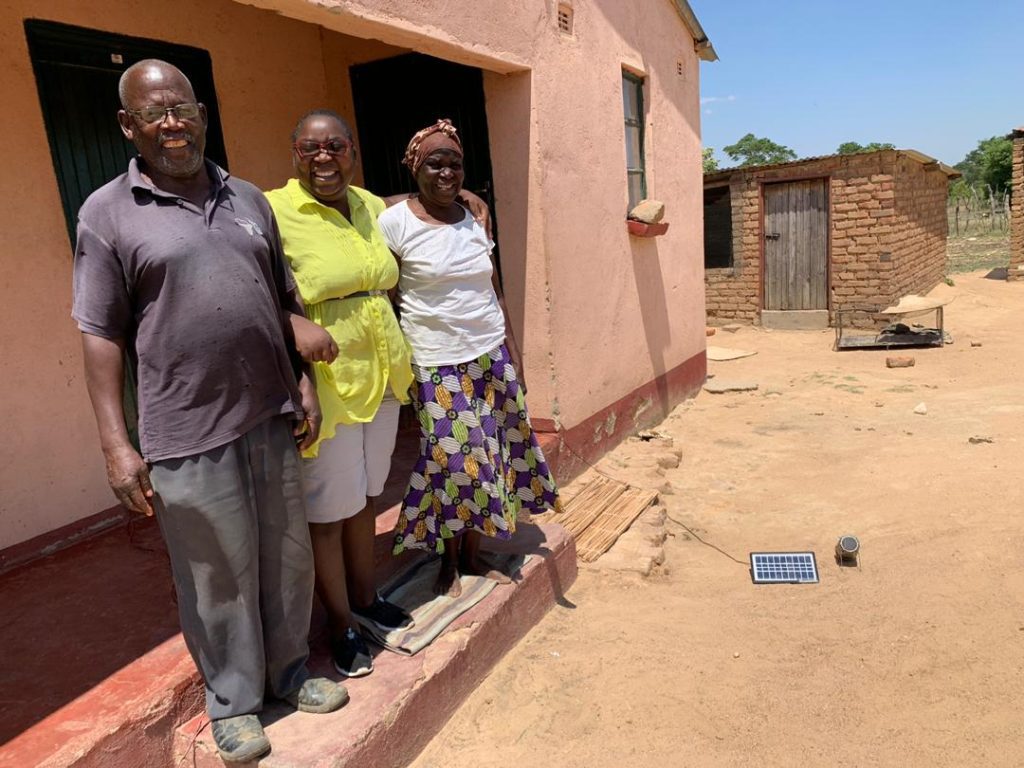 Esnath Divasoni (centre) with her parents at her cricket farm in Marondera, Zimbabwe.
