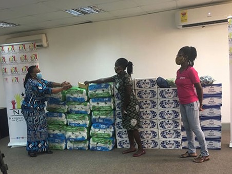 CAMFED Association member Angela Menyah donates soap and cleaning products to the NCCE in Ghana. 