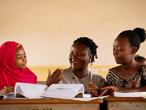 Stumai (center) coaching other CAMFED Association members. 
