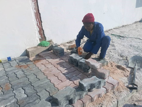 Misozi laying bricks Misozi laying bricks