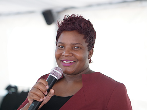 Patience holding a microphone
