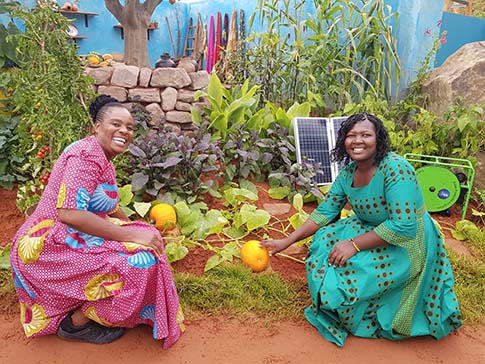 Sinikiwe and Clarah in the CAMFED Garden at the Chelsea Flower Show