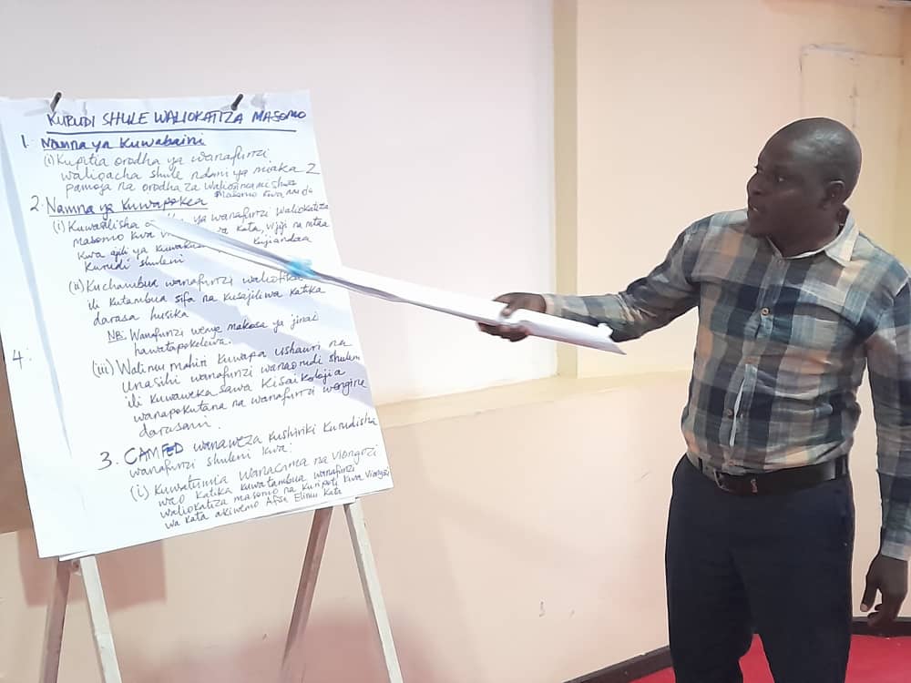 A District Education Officer in Tanzania making a presentation