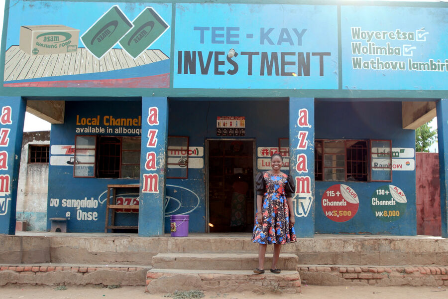 Thokozani, a young Malawian entrepreneur stands outside her store in Zomba, Malawi.