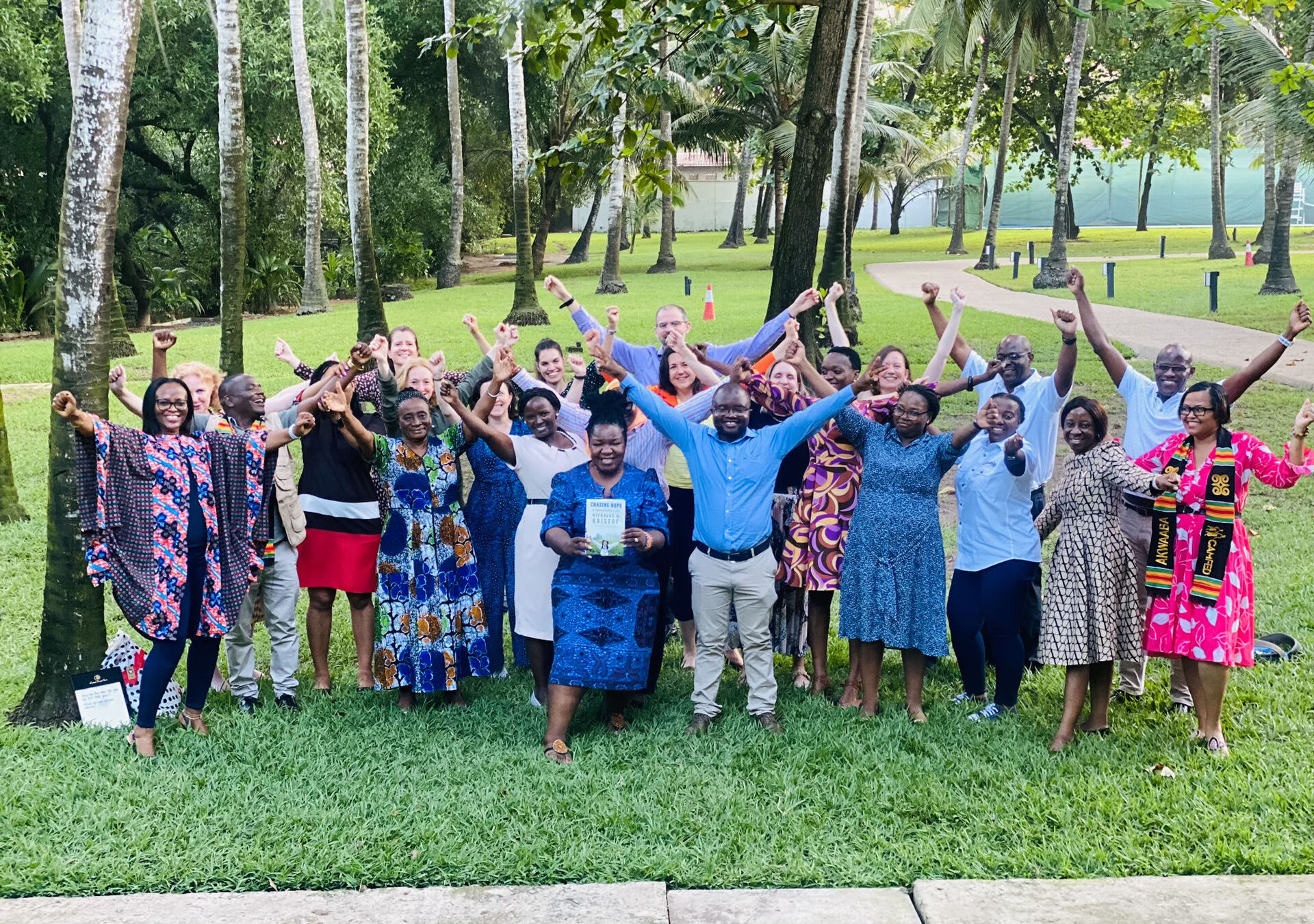 CAMFED Association members and Learner Guides Subira, Stumai, and Hilda check through By Better World exercise books