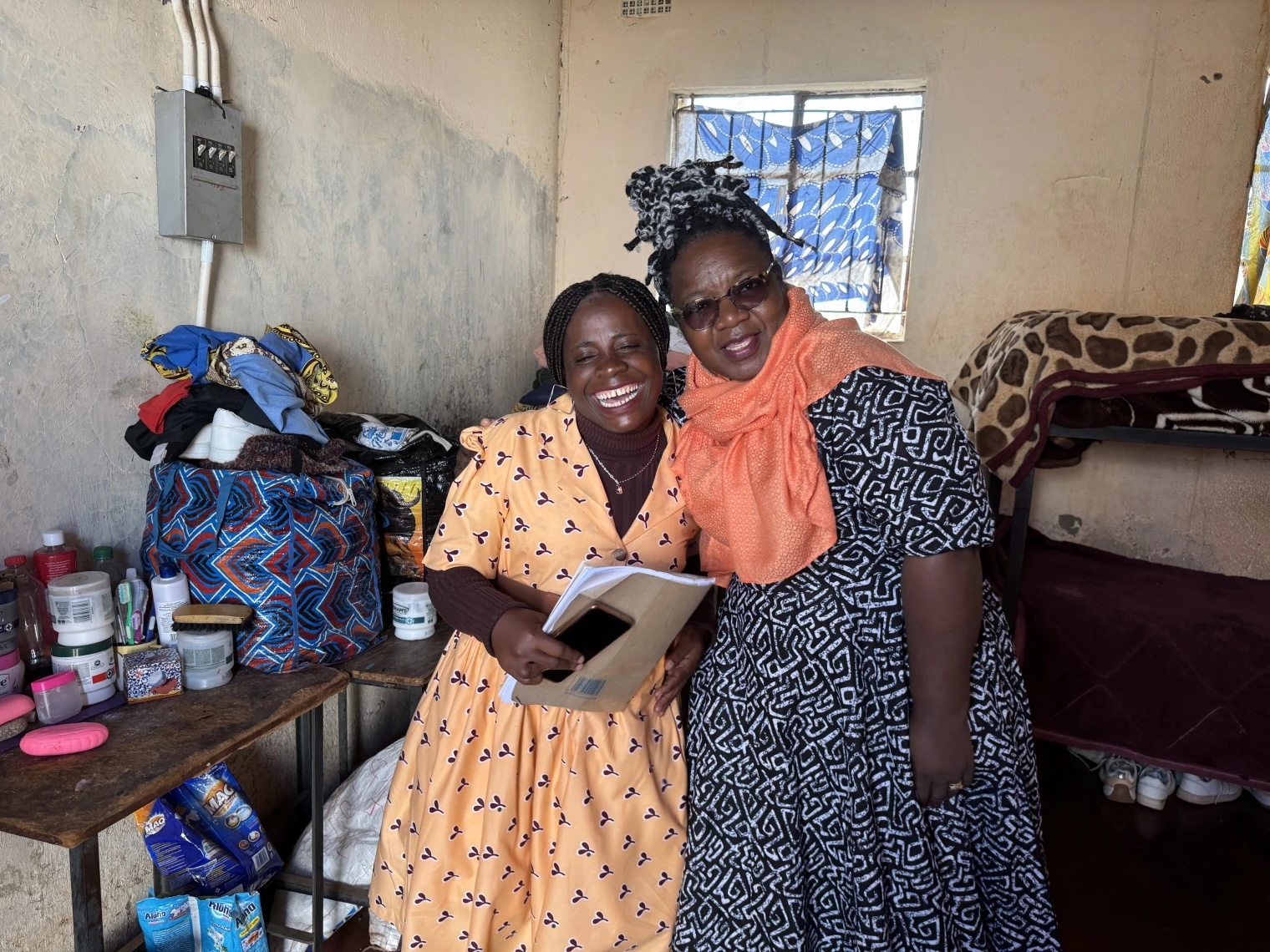Two women hugging and Smiling.